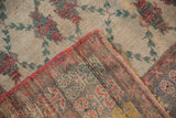 View of the hand-knotted back and intact red side cord on a vintage Oushak runner.