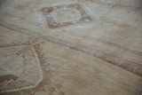 Abrashed field and geometric stepped contour on vintage distressed Oushak rug pile.