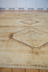 Distressed vintage Oushak carpet edge with muted geometric patterns and short pile.