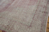 Distressed Sparta carpet detail: foundation wear, faded raspberry, ivory, and side fringe.