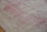 Textured detail of distressed vintage Sparta carpet showing foundation, raspberry red, and ivory.