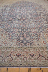 Distressed vintage Sparta rug showing time-softened floral arabesque and worn foundation.