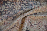 Textured detail of the Distressed Sparta carpet's low pile, revealing faded floral arabesque in beige and rust.
