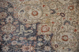 Distressed vintage Sparta rug pile showing floral arabesque, beige, charcoal, and rust hues.