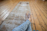 Distressed Oushak runner texture, showing foundation, subtle pattern, and time-softened hues.