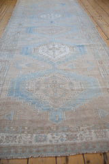 Distressed Serab runner's geometric medallion, stepped patterns in muted blue and sand.