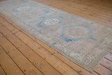 Distressed vintage Serab runner corner with low pile, abrash blues, and beige hexagonal motif.