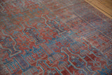Geometric germinating plants and nuanced checkered motifs on the distressed antique Belouch pile.