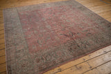 Distressed vintage Sparta rug edge with faded dusty blush and oxidized silver floral motifs.