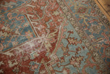 Vintage Distressed Heriz rug showing worn cherry brick red and denim blue patterns.
