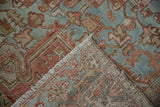 Distressed pile texture, hand-knotted foundation, and fringe on a vintage Heriz rug.