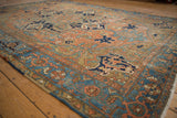 Distressed Karaja rug shows dusty brick red, navy blue, sky blue floral field.