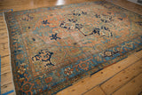 Distressed vintage Persian Karaja carpet corner, blue turtle border, faded brick-red field.
