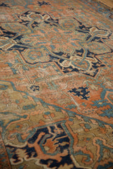 Distressed pile of the Karaja rug, featuring brick red, navy, and sky blue motifs.