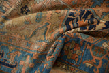 Distressed Karaja rug pile showing brick red, navy, and faded sky blue patterns.