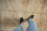 Distressed vintage Kars carpet texture with subtle abrashed geometric patterns in neutral tones.