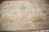 Secured edge and geometric border with faded patterns on a distressed Kars rug corner.