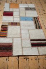 Seamed ivory and striped kilim flatweave fragments of the Turkish patchwork runner.