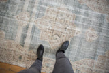 Distressed vintage Sparta rug showing faded medallion, abrashed pale blue and ivory pile.