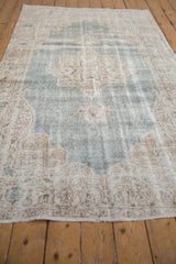 Distressed vintage Sparta carpet texture with faded pale denim blue and ivory patterns.