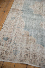 Worn pile texture and faded ivory border patterns on the vintage Distressed Sparta rug.
