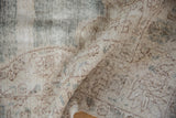 Folded distressed Sparta rug showcasing worn pile with exposed foundation and woven backing.
