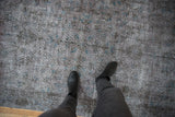 Distressed vintage Sparta rug, wear across to foundation, faded charcoal and sapphire pattern.