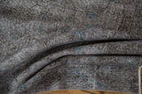 Textured distressed charcoal Sparta rug pile, with wear to foundation and subtle blue.