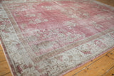 Distressed vintage Sparta carpet with faded rose floral motifs and antique ivory border.