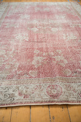 Distressed texture and faded soft rose blush floral patterns on a vintage Sparta rug.