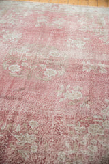 Distressed rose blush texture with faded floral pattern on a vintage Sparta rug.