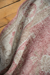 Distressed soft rose blush and antique ivory pile texture of the hand-knotted Sparta rug.