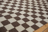 Tight, hand woven ivory and chocolate checkered pattern of the Indian Kilim.