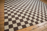 Southwestern hand woven Indian Kilim with ivory and chocolate brown checkered edge.