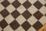 Detail of unique hand-woven Indian Kilim with ivory and chocolate Navajo-style checkered pattern.