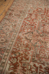 Distressed Heriz carpet main border showing geometric turtle motifs and even wear in aged red, ivory.