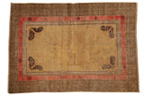 Antique Uzbeki Khotan rug with pale gold field, unique charcoal butterfly corners, geometric T-pattern border.