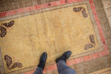 Antique Khotan rug with pale gold field, unique butterfly corners, and geometric borders.