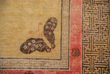 Antique Khotan rug corner: unusual butterfly with raspberry detail, geometric T-motif border.