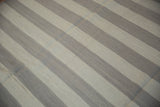 Hand woven Egyptian Kilim carpet featuring ivory and oxidized silver horizontal stripes and abrashes.