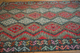 Afghani Kilim with cherry red geometric guls and dusty blue serrated floral bouquet motifs.