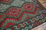 Colorful geometric motifs, serrated palmettes, and floral borders on this Afghani Kilim.