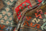 Hand woven Afghani Kilim showcasing repeating floral gul and serrated cloudband motifs.