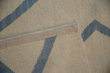 Textured ivory and pale denim blue hand woven Afghani Kilim showing original side selvage.