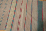 Close-up of vintage Afghani Kilim's striped pattern with beige, dusty green, and muted red.