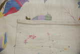 Back of a Pakistani kilim showing the finished side cord and reverse of bird embroidery.
