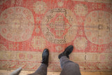 Vintage Khotan rug runner with worn pile, visible foundation, faded triple roundel and palmette designs.