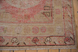 Vintage Khotan runner corner detail: pale cherry red, beige wave border, fringed edge.