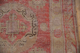 Vintage Khotan runner detail: dusty cherry red field, pale gold palmettes, chocolate accents, and wear.