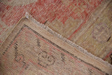 Hand-knotted foundation and fringe details of a vintage Uzbeki Khotan rug runner with worn pile.